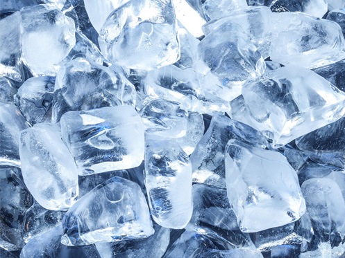 A close-up view of several clear ice cubes stacked together, with light reflecting off their smooth, angular surfaces. | High 5 Plumbing, Heating & Cooling