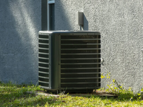 AC Unit Outside Stucco House