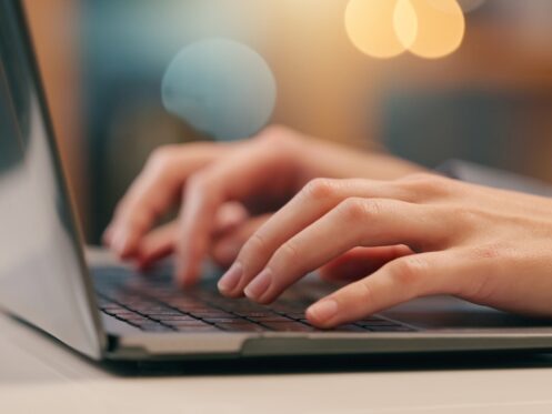 Persons Hand Working on Laptop